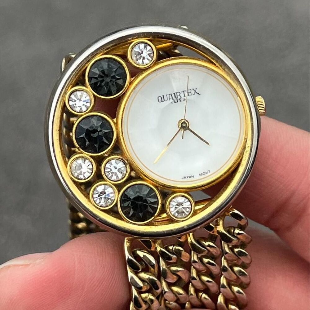 Quartex gold tone watch with gray & white rhinestones